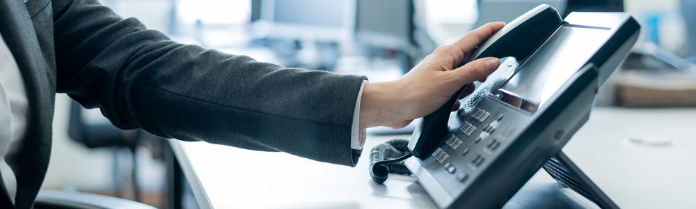 Person in an office using a landline