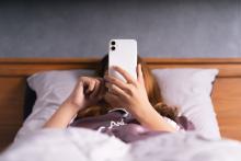 Person in bed on phone