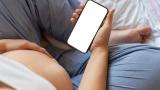 Pregnant person with smart phone