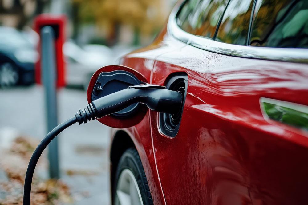 Red electric car being charged