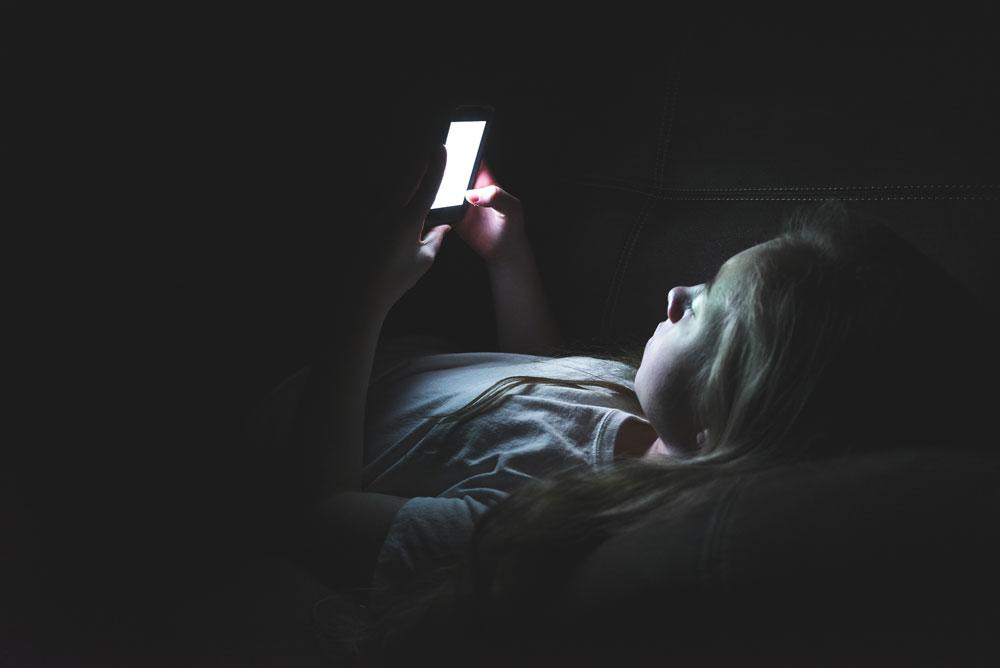 Girl in the dark on a smartphone