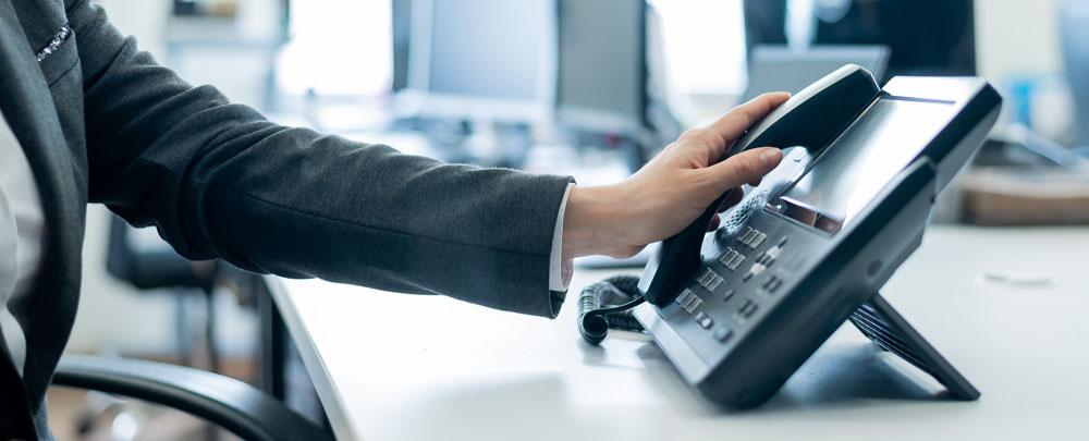 Person in an office using a landline