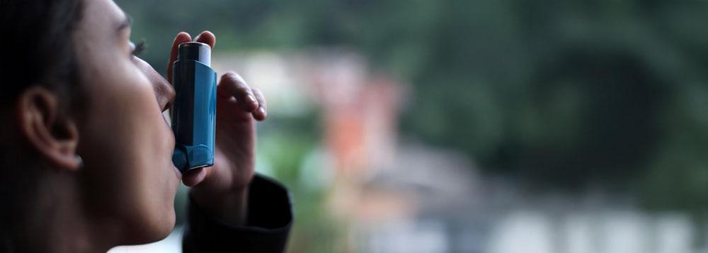 Woman using inhaler