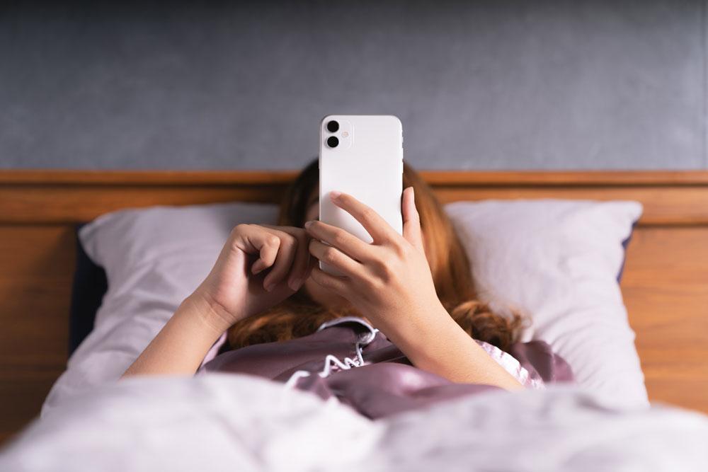 Person in bed on phone